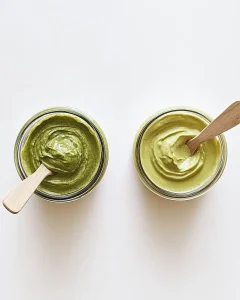 Side-by-side jars of pistachio cream vs butter highlighting the difference in texture and color