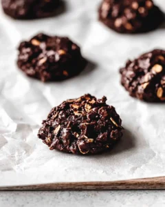 Close-up hero shot of rich, fudgy dark chocolate no bake cookies showing texture and oat pieces