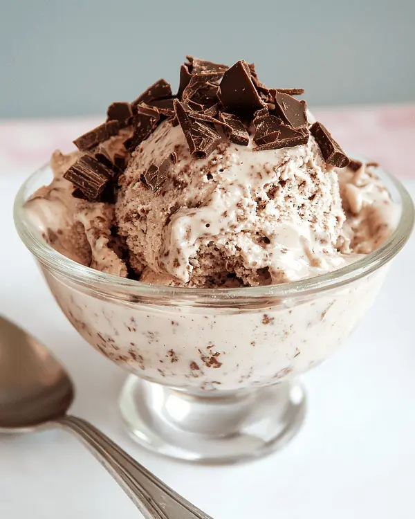 French Silk Pie Ice Cream 4 A bowl of French silk pie ice cream topped with chocolate shavings and pie crust.