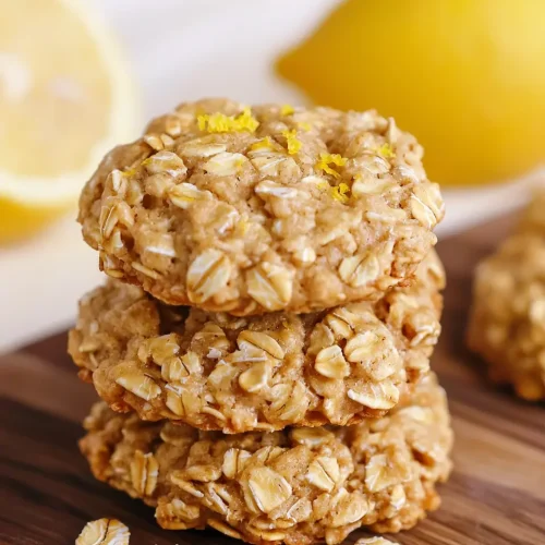 Lemon Oatmeal No Bake Cookies Recipe 5 Stack of freshly made lemon oatmeal no bake cookies showing golden color and oat texture on wooden cutting board