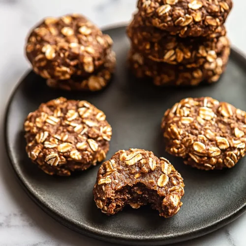 No Bake Protein Cookies 5 Close-up hero shot of no bake protein cookies showing rich chocolate color and oat texture with one cookie featuring a bite taken out