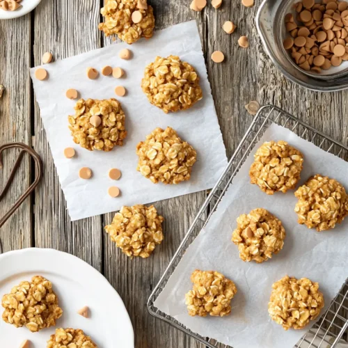 Ultimate Oatmeal Butterscotch No Bake Cookies 5 Freshly made oatmeal butterscotch no bake cookies cooling on parchment paper and displayed on plates in a warm kitchen setting