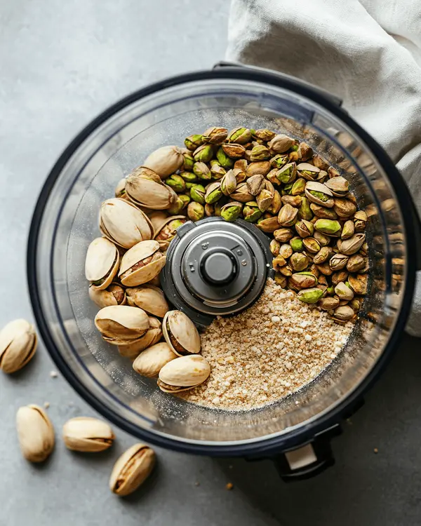 The Complete Guide to Homemade Pistachio Butter 2 Three stages of making pistachio butter in food processor from whole nuts to smooth paste