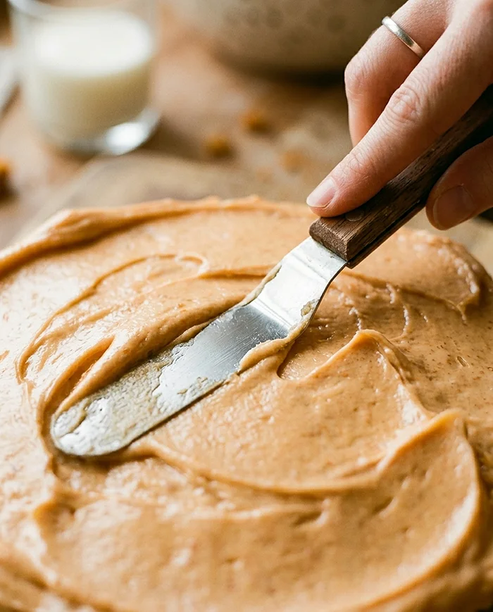 sweet potato frosting spread on homemade cake